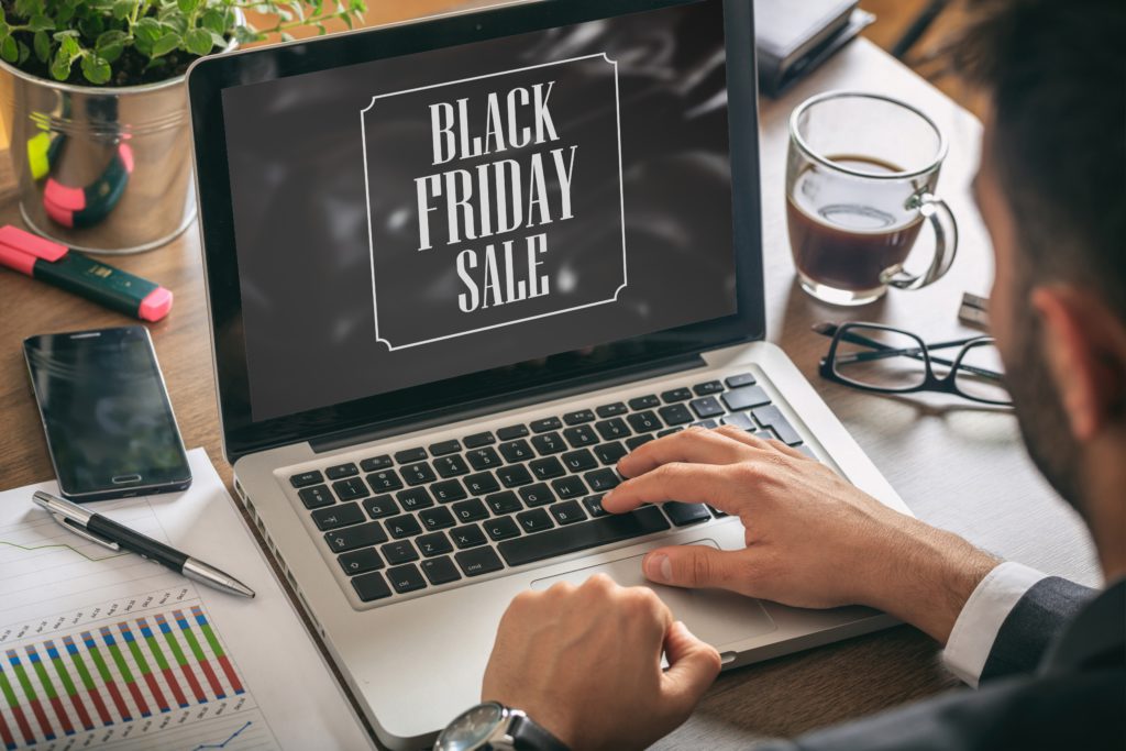 Black Friday sale text on a laptop screen, office background